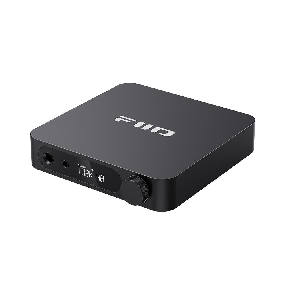 FiiO K11 desktop DAC and headphone amp in black, front three-quarter view showing the headphone outputs, LCD display and volume knob