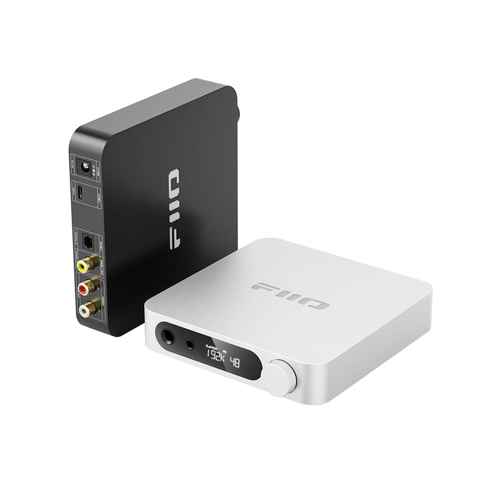FiiO K11 in black and silver side by side, the black unit standing upright to show its rear-panel connectors