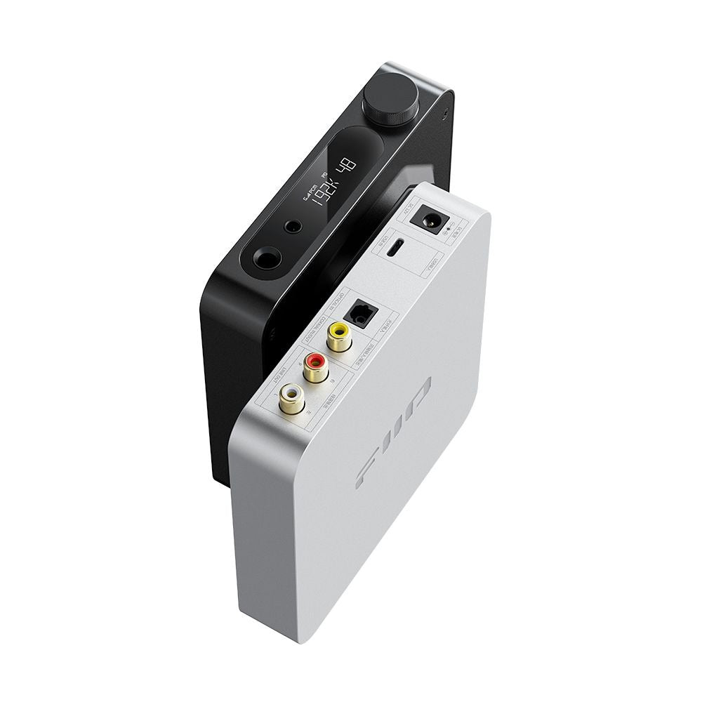 Overhead view of FiiO K11 black and silver units showing the rear panel with power, USB-C, optical, coaxial and RCA connectors